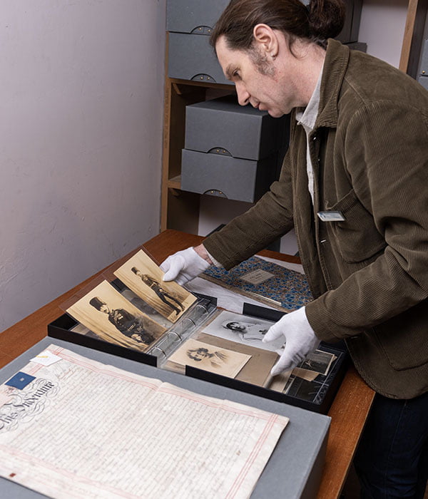 An archivist looking down at some documents.