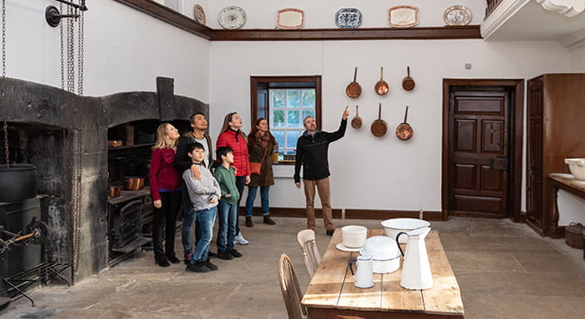 A tour group in the kitchen at Strokestown.