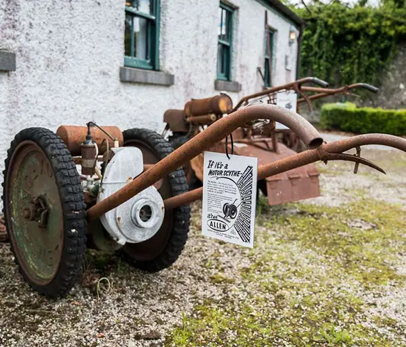 An old piece of farm equipment with two large wheels