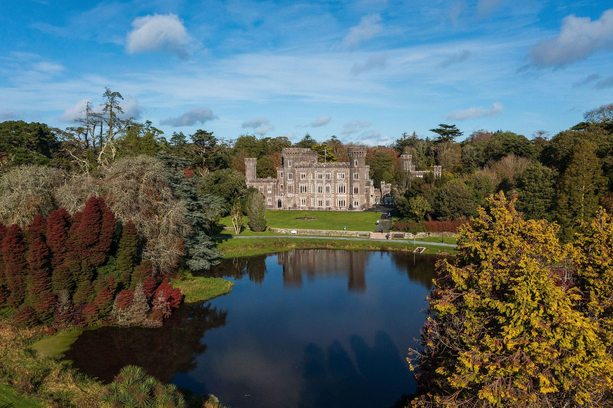 Aerial photo of gothic revival castle with lage in foreground