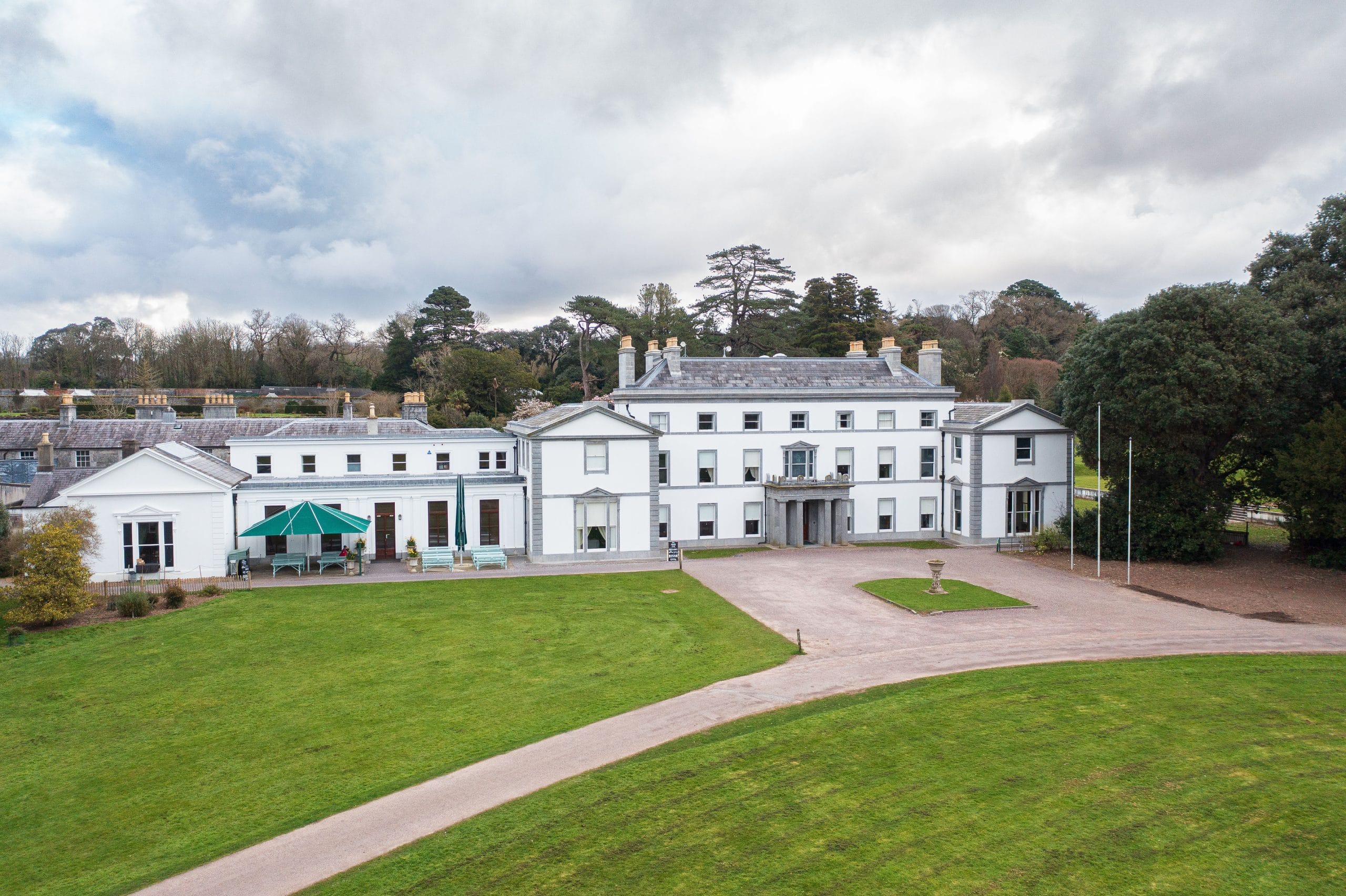 Facade photo of historic Fota house with grass in foreground