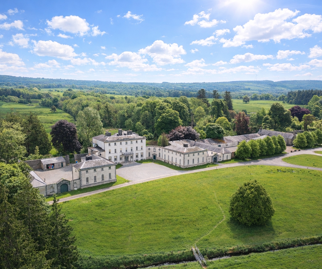 Aerial shot of Strokestown Park | The National Famine Museum, Roscommon, surrounded by fields at front and woodlands to the back